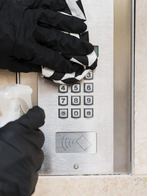 hands-with-gloves-disinfecting-interphone